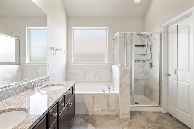 110 N Sage Holw, Dripping Springs, TX 78620 - bathroom with a garden tub, double vanity, a shower stall, and tile patterned floors