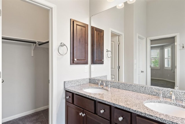 110 N Sage Holw, Dripping Springs, TX 78620 - full bathroom featuring double vanity and a walk in closet