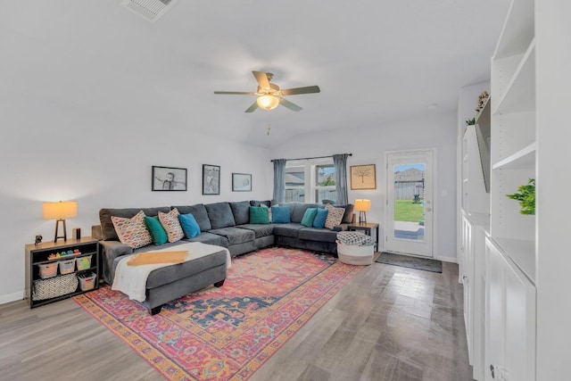 200 Waterway Ave, Hutto, TX 78634 - living area with wood finished floors, ceiling fan, vaulted ceiling, and baseboards