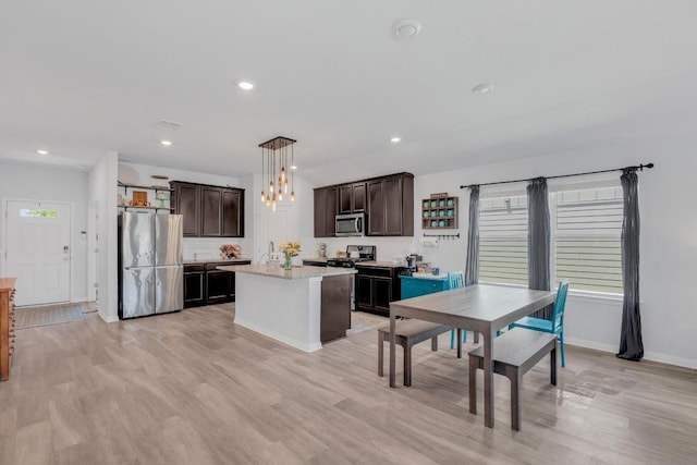200 Waterway Ave, Hutto, TX 78634 - kitchen featuring appliances with stainless steel finishes, dark brown cabinets, light wood-style flooring, pendant lighting, and recessed lighting