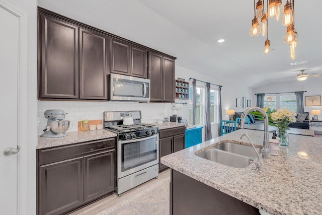 200 Waterway Ave, Hutto, TX 78634 - kitchen with stainless steel appliances, a sink, dark brown cabinetry, backsplash, and recessed lighting