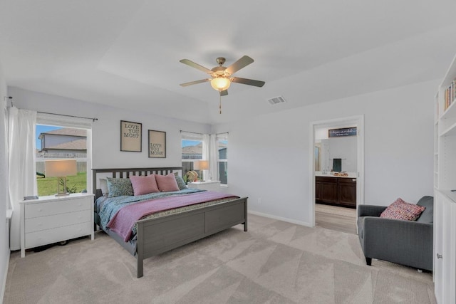 200 Waterway Ave, Hutto, TX 78634 - bedroom featuring light colored carpet, baseboards, ceiling fan, and ensuite bathroom