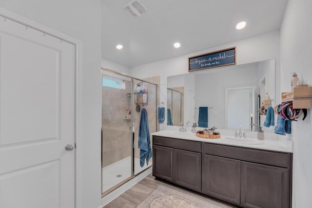 200 Waterway Ave, Hutto, TX 78634 - full bathroom with a shower stall, double vanity, and wood finished floors