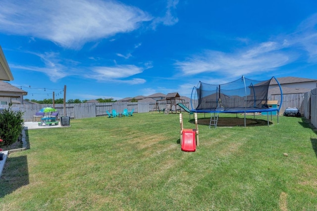 200 Waterway Ave, Hutto, TX 78634 - fenced backyard with a trampoline, a playground, and a patio area