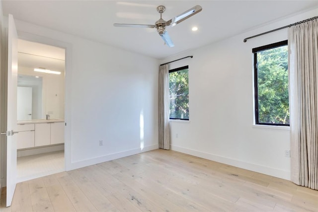 2901 S 5th St, Austin, TX 78704 - unfurnished bedroom featuring light wood finished floors, baseboards, recessed lighting, and ensuite bathroom