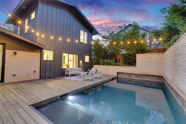 2901 S 5th St, Austin, TX 78704 - pool at dusk featuring outdoor lounge area, an outdoor pool, and a wooden deck