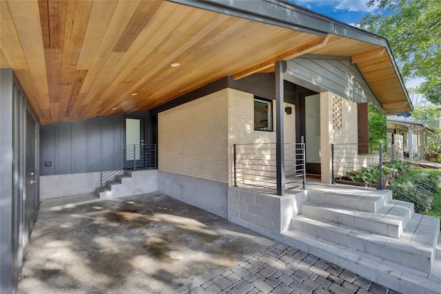 2901 S 5th St, Austin, TX 78704 - doorway to property featuring brick siding, a porch, and board and batten siding