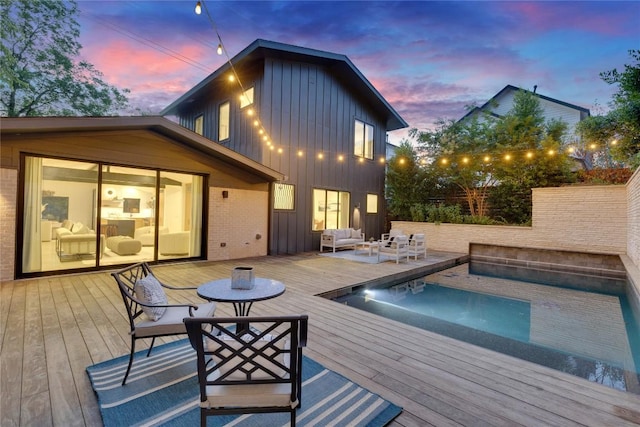2901 S 5th St, Austin, TX 78704 - pool at dusk featuring an outdoor living space, a deck, and an outdoor pool