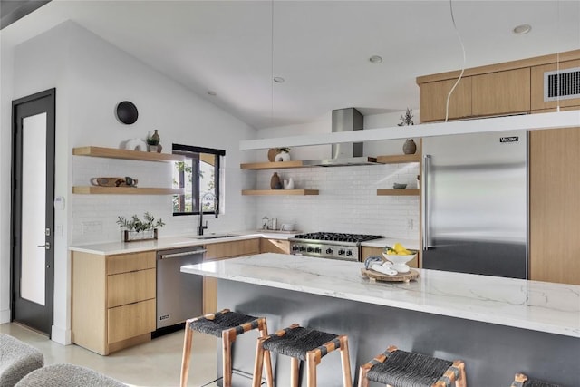 2901 S 5th St, Austin, TX 78704 - kitchen with open shelves, stainless steel appliances, wall chimney exhaust hood, tasteful backsplash, and lofted ceiling