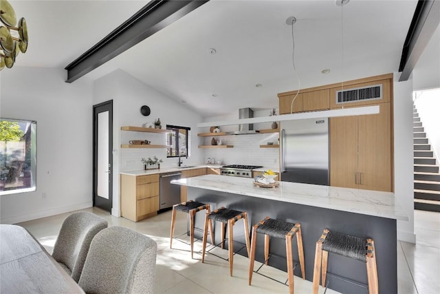 2901 S 5th St, Austin, TX 78704 - kitchen featuring appliances with stainless steel finishes, open shelves, decorative backsplash, a breakfast bar, and wall chimney range hood