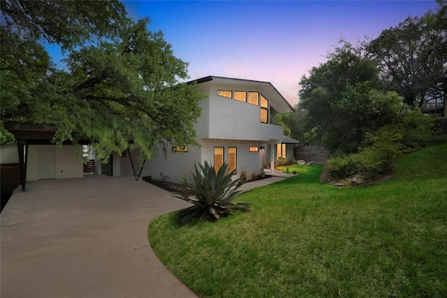 2502 Side Cv, Austin, TX 78704 - view of front of property with concrete driveway, stucco siding, and a lawn