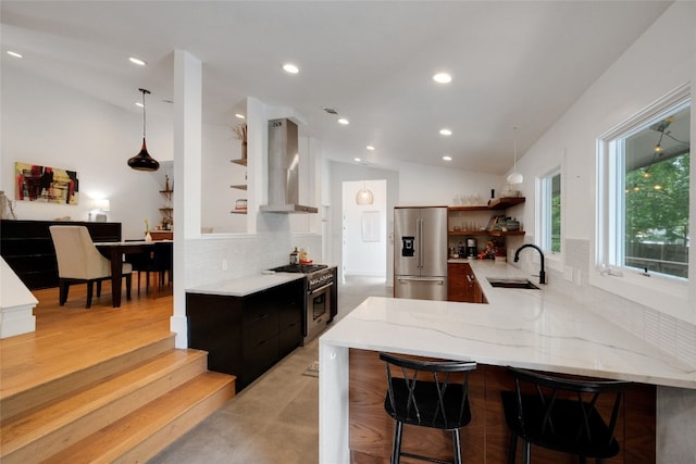 2502 Side Cv, Austin, TX 78704 - kitchen featuring stainless steel appliances, open shelves, wall chimney exhaust hood, a sink, and decorative backsplash