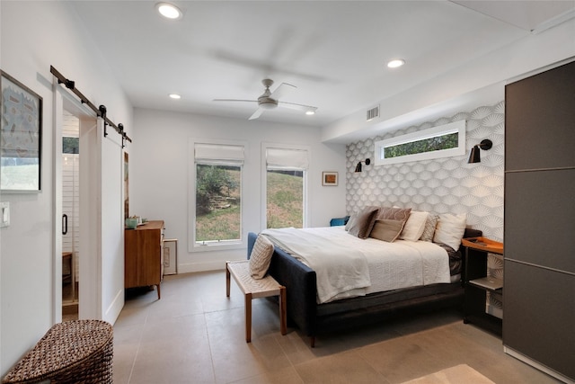 2502 Side Cv, Austin, TX 78704 - bedroom with a barn door, recessed lighting, an accent wall, baseboards, and ceiling fan