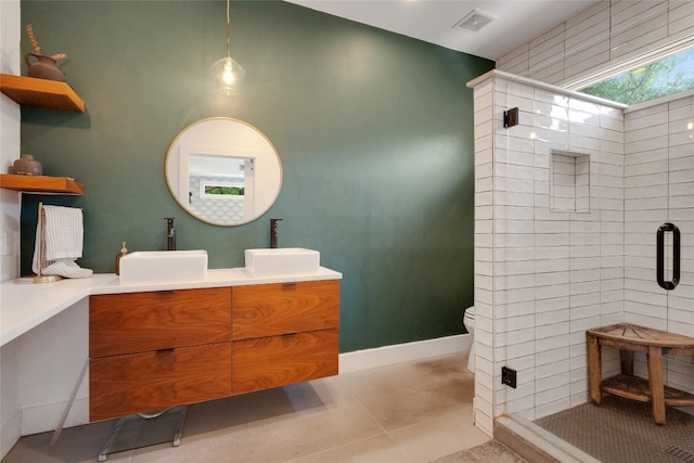 2502 Side Cv, Austin, TX 78704 - full bathroom with double vanity, a stall shower, toilet, and tile patterned floors