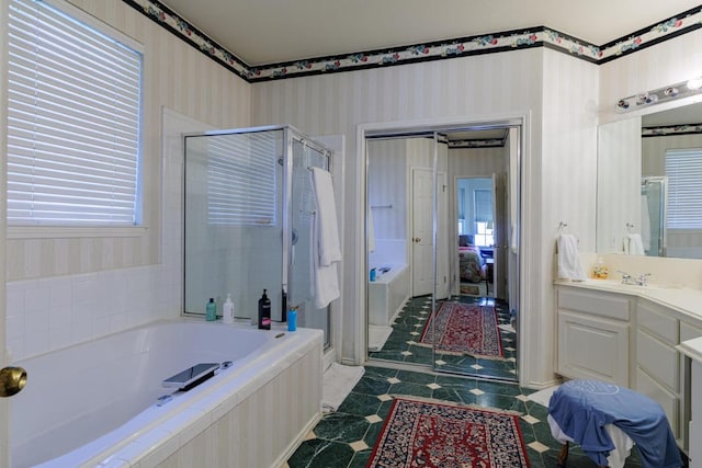 ensuite bathroom featuring a garden tub, a stall shower, wallpapered walls, vanity, and tile patterned flooring