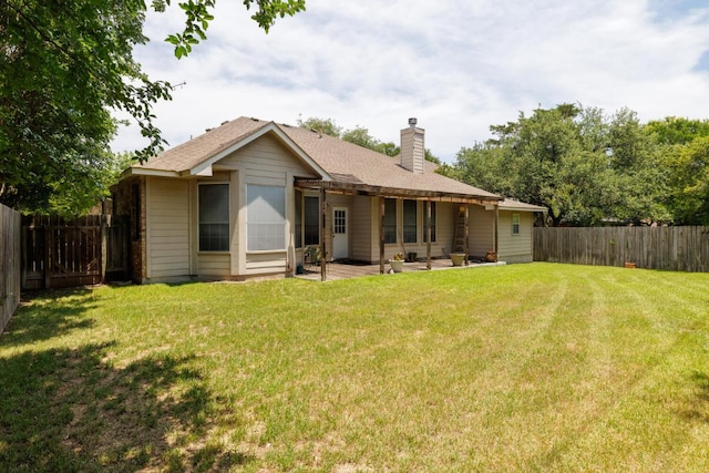 back of house featuring a chimney, a patio, and a shingled roof