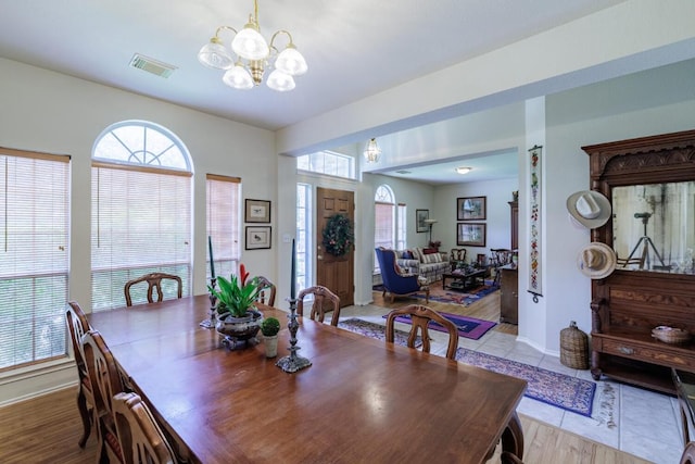 dining area with a chandelier, healthy amount of natural light, and baseboards