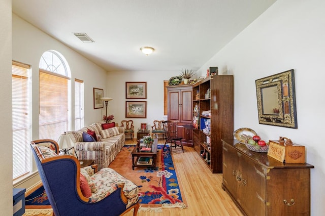 living area featuring light wood-type flooring and healthy amount of natural light