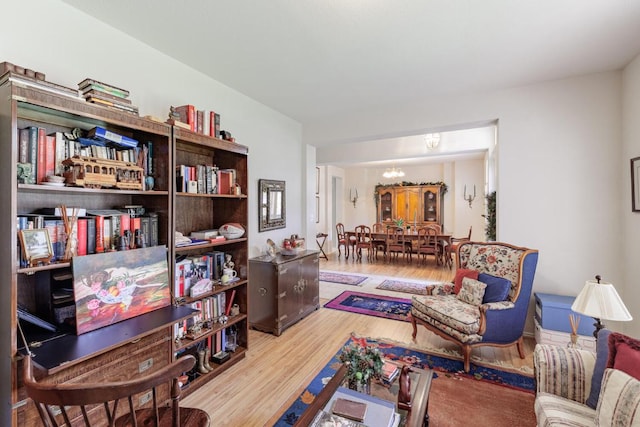 living room with a chandelier and wood finished floors