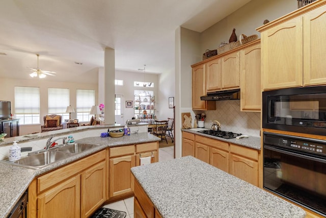 kitchen with black appliances, a sink, under cabinet range hood, light brown cabinetry, and decorative backsplash