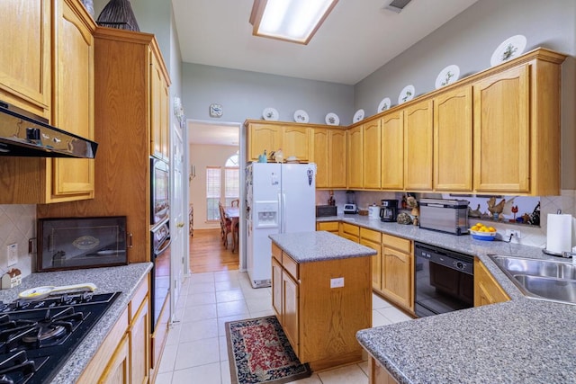 kitchen featuring black appliances, light tile patterned flooring, a sink, and tasteful backsplash