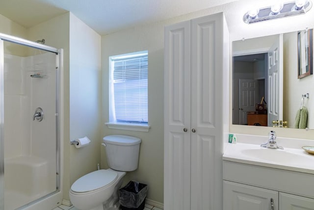 bathroom featuring a shower stall, vanity, and toilet