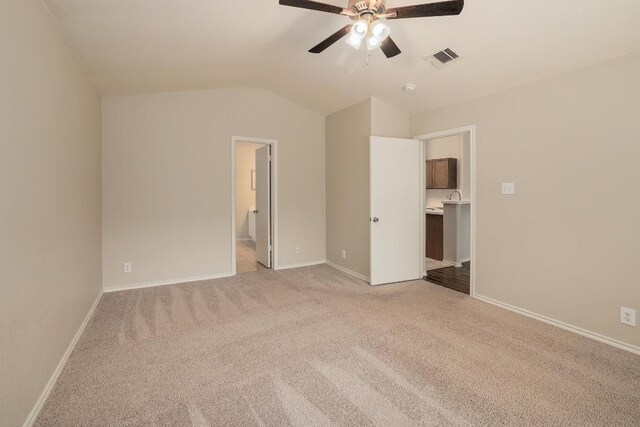16710 Shipshaw River Dr, Leander, TX 78641 - unfurnished bedroom with light colored carpet, vaulted ceiling, baseboards, ensuite bath, and a ceiling fan