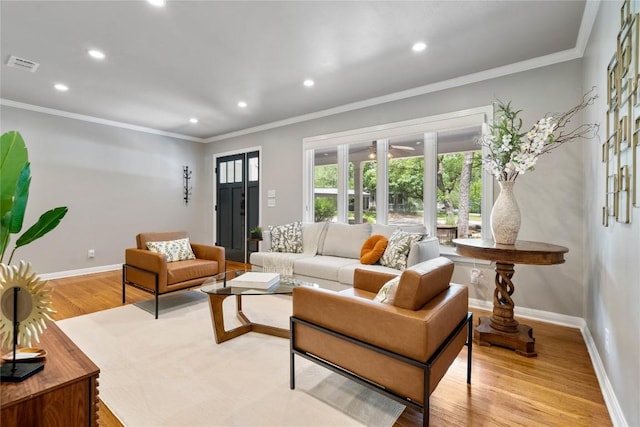 2601 W 49th St, Austin, TX 78731 - living room featuring recessed lighting, crown molding, and light wood-type flooring