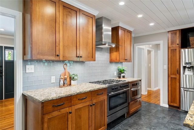 2601 W 49th St, Austin, TX 78731 - kitchen with wall chimney exhaust hood, stainless steel appliances, crown molding, tasteful backsplash, and brown cabinetry