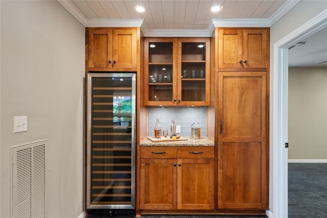 2601 W 49th St, Austin, TX 78731 - indoor dry bar with wine cooler, ornamental molding, backsplash, and recessed lighting