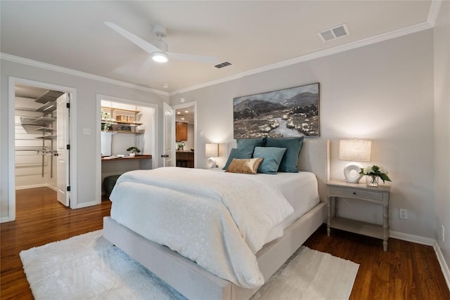 2601 W 49th St, Austin, TX 78731 - bedroom featuring crown molding, wood finished floors, a spacious closet, baseboards, and ceiling fan