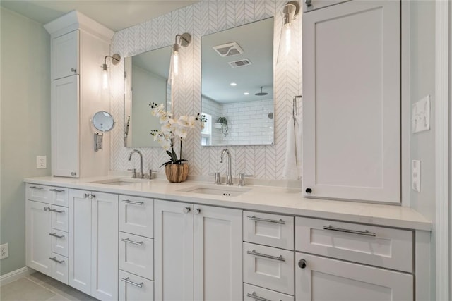 2601 W 49th St, Austin, TX 78731 - bathroom featuring tiled shower, double vanity, decorative backsplash, and tile patterned flooring