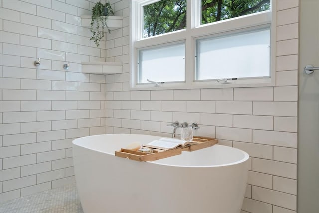 2601 W 49th St, Austin, TX 78731 - full bath featuring tile walls, a soaking tub, and tile patterned floors