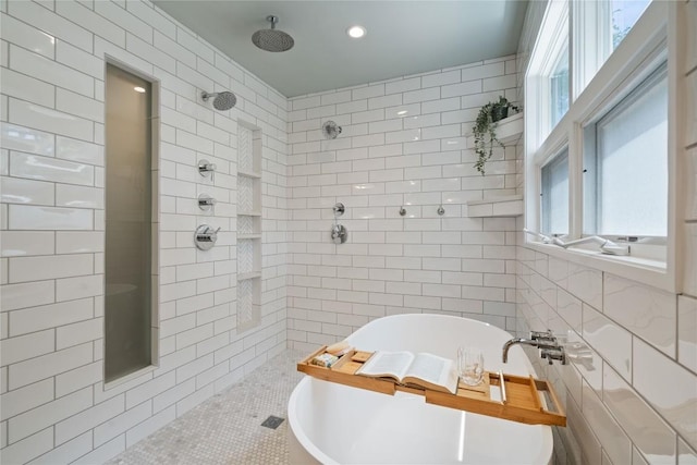 2601 W 49th St, Austin, TX 78731 - bathroom featuring tile walls, a tile shower, plenty of natural light, and a freestanding tub