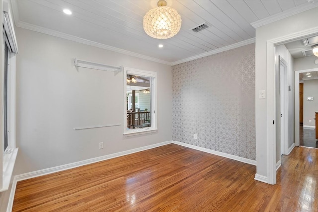 2601 W 49th St, Austin, TX 78731 - empty room with wood finished floors, a chandelier, baseboards, ornamental molding, and recessed lighting