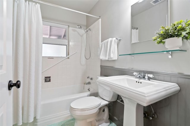 2601 W 49th St, Austin, TX 78731 - bathroom featuring shower / tub combo, toilet, wainscoting, and a sink
