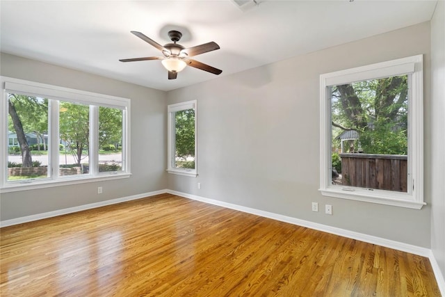 2601 W 49th St, Austin, TX 78731 - spare room featuring wood finished floors, baseboards, and a ceiling fan