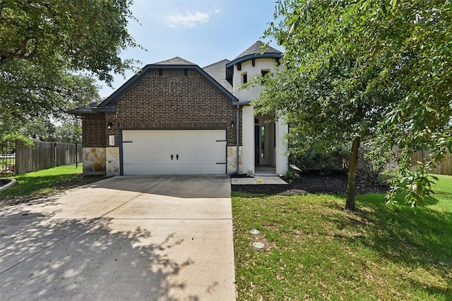 125 Redtail Ln, Leander, TX 78641 - view of front facade featuring an attached garage, driveway, stone siding, and brick siding