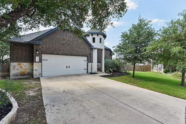 125 Redtail Ln, Leander, TX 78641 - view of front of home with a garage, brick siding, concrete driveway, and stone siding