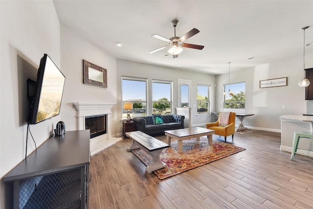 125 Redtail Ln, Leander, TX 78641 - living area with plenty of natural light, a ceiling fan, baseboards, and wood finished floors