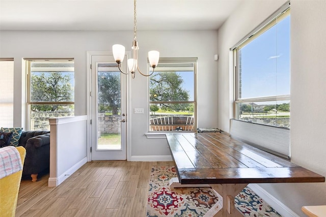 125 Redtail Ln, Leander, TX 78641 - dining space with light wood-type flooring, a chandelier, and baseboards