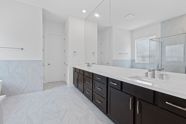 1616 Illawarra Way, Leander, TX 78641 - full bathroom with a shower stall, double vanity, tile walls, and recessed lighting