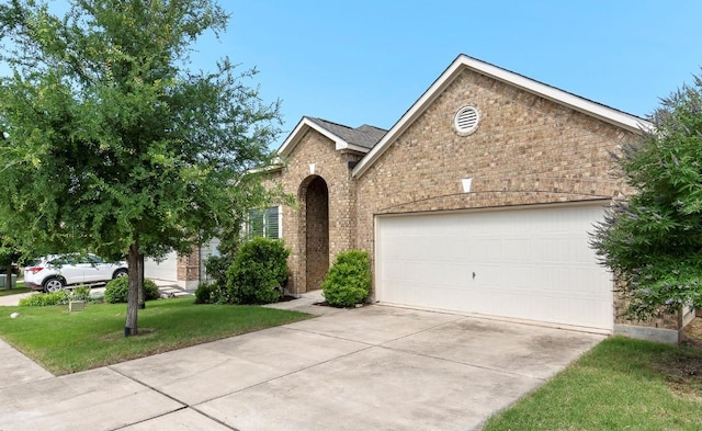 7604 Nunsland Dr, Austin, TX 78744 - traditional-style home featuring brick siding, driveway, an attached garage, and a front lawn