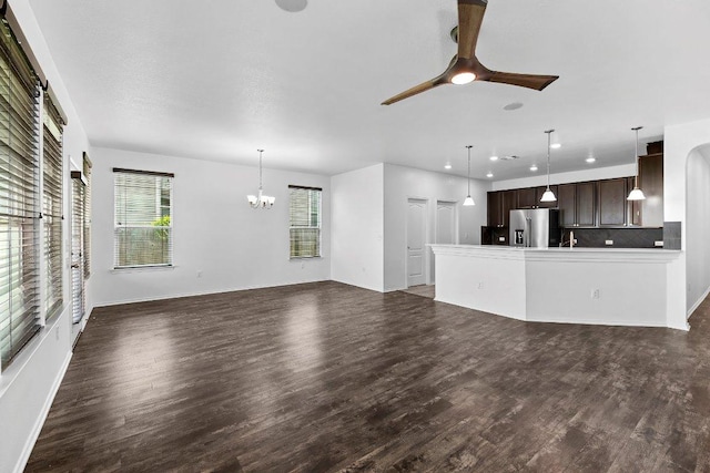 7604 Nunsland Dr, Austin, TX 78744 - unfurnished living room featuring a ceiling fan, a chandelier, wood finished floors, recessed lighting, and a sink
