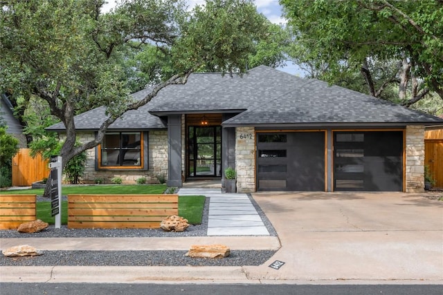 6412 Steer Trl, Austin, TX 78749 - view of front facade with stone siding, roof with shingles, driveway, and an attached garage