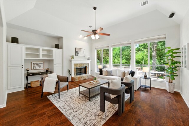1607 Mesa Verde Dr, Round Rock, TX 78681 - living room with ceiling fan, plenty of natural light, a tiled fireplace, dark wood-style flooring, and lofted ceiling