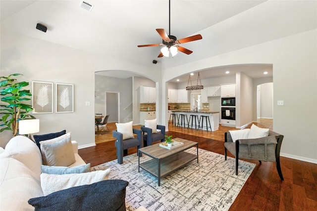 1607 Mesa Verde Dr, Round Rock, TX 78681 - living area featuring arched walkways, a ceiling fan, wood finished floors, baseboards, and recessed lighting