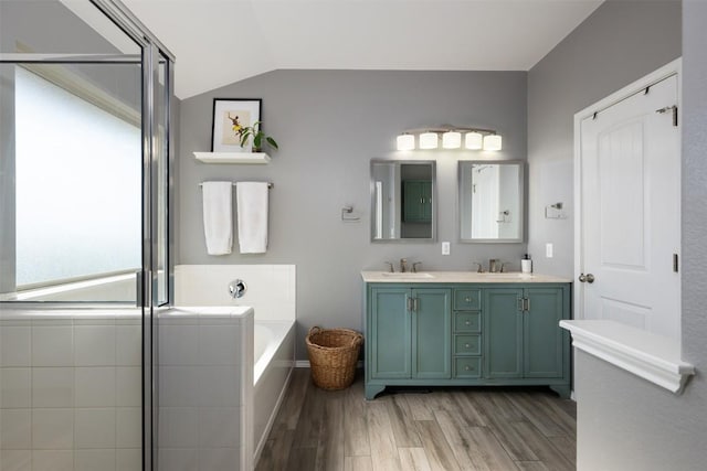 361 Stone View Trl, Austin, TX 78737 - full bath featuring wood finished floors, double vanity, a garden tub, vaulted ceiling, and a shower with door