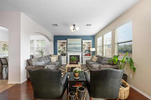 361 Stone View Trl, Austin, TX 78737 - living area with arched walkways, dark wood-style floors, and healthy amount of natural light