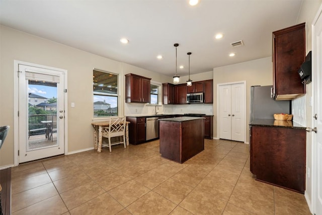 361 Stone View Trl, Austin, TX 78737 - kitchen featuring appliances with stainless steel finishes, a kitchen island, a sink, recessed lighting, and light tile patterned flooring